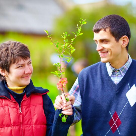 portrait of happy woman and man with disability together on spring lawn - Home and Community-Base Waiver Services
