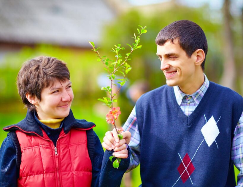 portrait of happy woman and man with disability together on spring lawn - Home and Community-Base Waiver Services